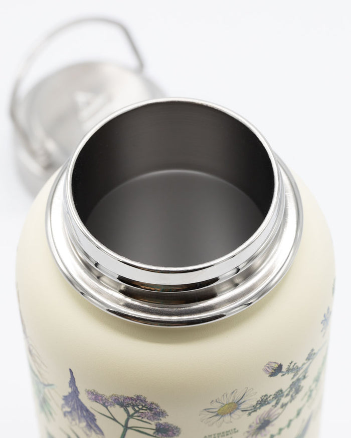 A Botanical Pharmacy 32 oz Steel Bottle with a lid and flowers on it, made by Cognitive Surplus.