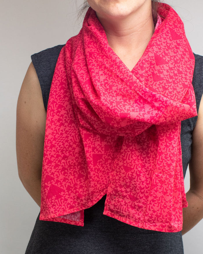 A woman wearing a Cognitive Surplus Cellular Automata Scarf.