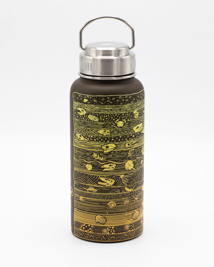 A Core Sample 32 oz Steel Bottle by Cognitive Surplus with a gold and brown design.