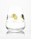 A Hominid Skulls Wine Glass with a Cognitive Surplus design on it.