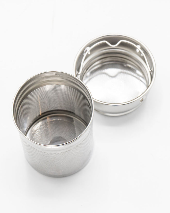 An Infuser Basket for Stainless Steel Bottles with a lid on a white surface. (Brand: Cognitive Surplus)