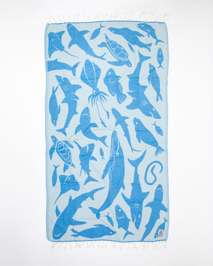 An Ocean Explorer Turkish Towel with sharks and fish on it from Cognitive Surplus.