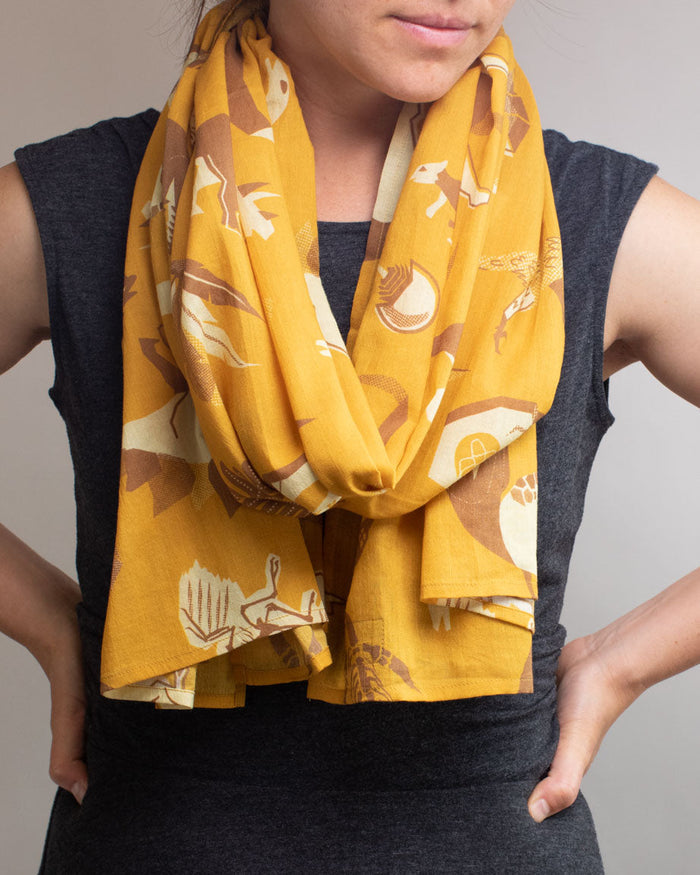 A woman wearing a Retro Paleontology Scarf by Cognitive Surplus.