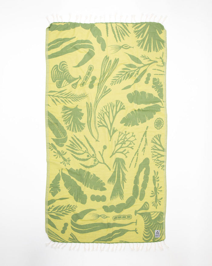 A Seaweed Turkish Towel with green leaves on it.